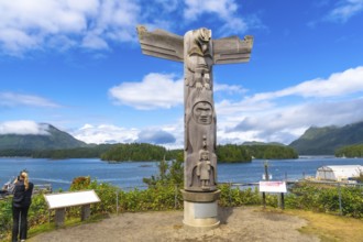 Wooden totem pole overlooking the ocean inlet in tofino, a small district on vancouver island in
