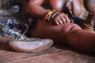 Detail, Himba perfume, scented smoke from burning plants, Himba village, Kaokoveld, Kunene, Namibia