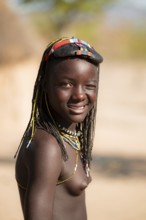 Portrait, brightly decorated girl winking, Hakaona tribe, also Havakona or Hakawona, near Opuwo,