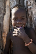Portrait, cheerful Himba child, traditional Himba village, Kaokoveld, Kunene, Namibia