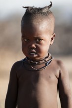 Portrait, young Himba child, traditional Himba village, Kaokoveld, Kunene, Namibia