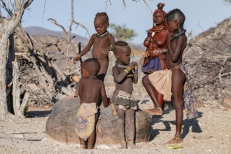 Himba children and woman, traditional Himba village, Kaokoveld, Kunene, Namibia