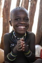 Portrait, grinning Himba child, traditional Himba village, Kaokoveld, Kunene, Namibia
