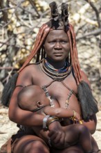 Himba woman with baby, portrait, traditional Himba village, Kaokoveld, Kunene, Namibia
