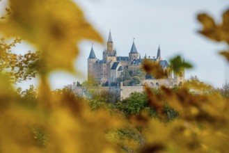 Castle and autumnal forest, Hohenzollern Castle, Hechingen, Swabian Jura, Baden-Württemberg,