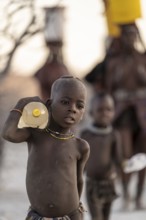 Himba children fetches water, carries water bottle, traditional Himba, Kaokoveld, Kunene, Namibia