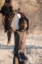 Himba child fetches water, carries canisters, traditional Himba, Kaokoveld, Kunene, Namibia