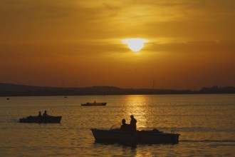 Boats sailing on a lake at sunset, romantic evening mood, Steonhude Steinhuder Meer