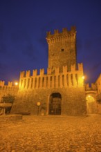 The castle and defensive walls illuminated, Borgo di Vigoleno, Vernasca, Province of Piacenza,