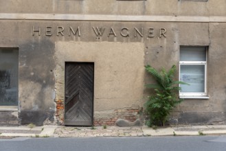 Dilapidated building with the inscription Herm Wagner, Altenburg, Thuringia, Germany