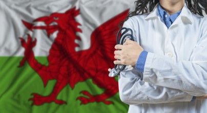 Healthcare professional with Wales flag background. Professional doctor holding stethoscope on