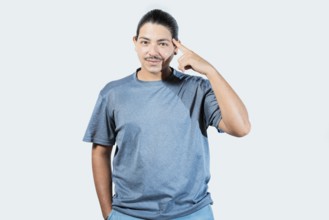 Pensive asian man with doubtful expression isolated. Thoughtful guy looking at camera isolated