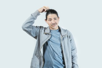 Confused guy scratching head isolated. Worried man scratching head with confused face isolated