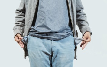 Closeup of person with empty pockets isolated. Concept of poverty and economic crisis