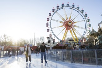 Skaters in front of the Ferris wheel at the Berlin Christmas market on Alexanderplatz, Berlin, 15