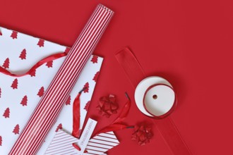 Top view of red and white Christmas wrapping material like bags, paper and ribbons