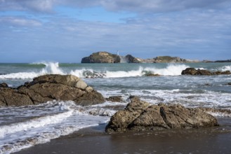 Castlepoint Beach and Castlepoint Lighthouse, ocean, waves, surf, sandy beach, rocks. Castlepoint,