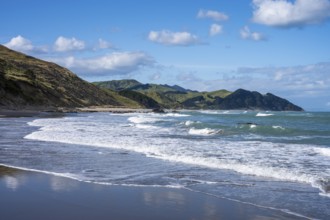 Castlepoint Beach, ocean, sandy beach, surf, mountains. Castlepoint, Wairarapa Coast, Wellington