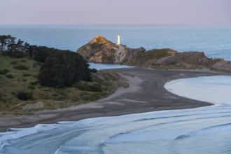 Deliverance Cove and Castlepoint Lighthouse on the rock, ocean, evening. Castlepoint, Wairarapa