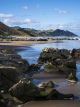 Castlepoint Beach, ocean, sandy beach, rocks, mountains. Castlepoint, Wairarapa Coast, Wellington