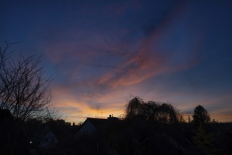 Evening sky with house and tree silhouettes, Eckental, Middle Franconia, Bavaria, Germany