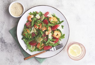 Fresh shrimp salad with arugula, grapefruit, and parmesan served in a bowl