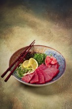 Tuna sashimi with daikon and wakame salad, pickled ginger, in a bowl