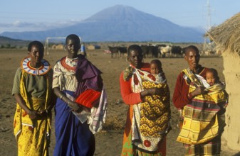 Women with babies pose for the camera in front of Mount Meru near Arusha, Tanzania, Africa, June