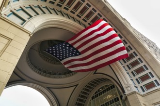 American flag fluttering, distinctive archway, Boston Harbor Hotel, Rowes Wharf, Freedom Trail,