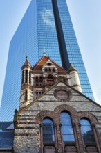 Trinity Church in front of glass façade, John Hancock Tower, various architectural styles on Copley