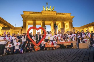 Activists from Fridays For Future pose with I love Paris T-shirts to mark the tenth anniversary of