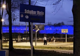 Schalker Meile sign at Ernst-Kuzorra-Platz in front of the royal blue illuminated Glückauf battle