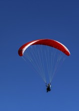 Paragliders against a blue sky, Val d'Anniviers, Valais Alps, Canton of Valais, Switzerland
