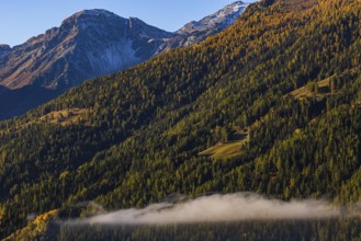 Fog rises over the mountain slopes of the Val d'Anniviers, Valais Alps, Canton of Valais,