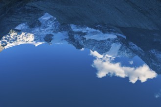 The Moiry glacier and mountain peaks are reflected in Lac de Chateaupre, Val d'Anniviers, Valais