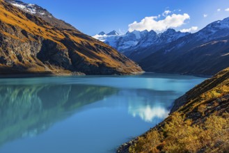 The Lac de Moiry reservoir, with the snow-capped peaks of the Grand Cornier, Tete Blanche and