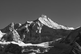 Snowy peak of Zinalrothorn mountain, black and white photo, Val d'Anniviers, Valais Alps, Canton of