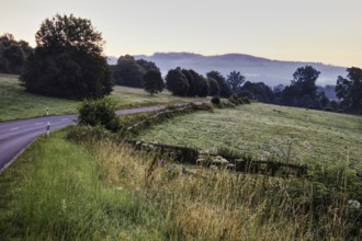 Peaceful rural scene with a country road and fog in the background, Kreuztal, Siegerland