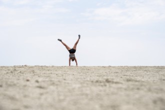 Abstract, woman doing gymnastics in a whirring landscape, Etosha pan, Etosha National Park, Namibia