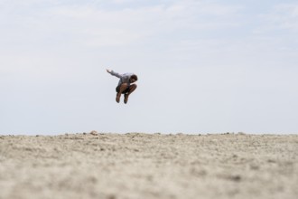 Abstract, man jumping at Etosha pan, salt pan, Etosha National Park, Namibia