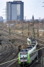 S-Bahn train on the route east, in front of Essen main station, town hall, regional transport North