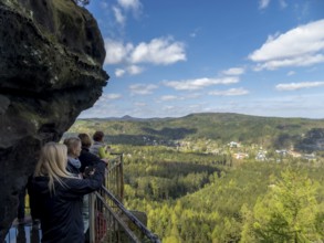 Hikers at a viewpoint with rocks, panoramic view of the landscape on Oybin, Zittau Mountains,