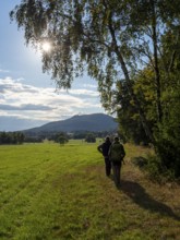 Hiker on sunny trail at Wiesenrand, Lückendorf, Zittau Mountains, Saxony, Germany