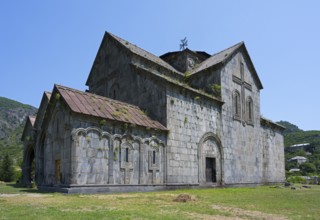 Historic stone church in rural area under blue sky, Romanesque style, Akhtala monastery, Akhtala