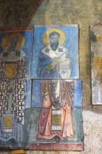 Icon painting on an old stone church wall depicting holy figures, Akhtala monastery, Akhtala, town
