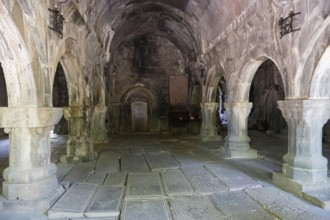 Vaulted room with stone structures and subdued lighting creates a cool atmosphere steeped in