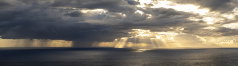 Sunset, sun rays over sea, dark rain cloud, rain, Madeira, Portugal