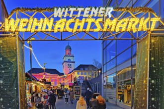 The entrance to the Witten Christmas market with the illuminated town hall, Ruhr area, North