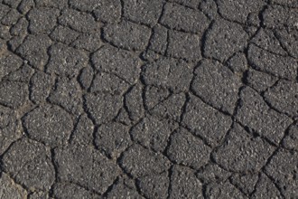Top view and close-up of cracked asphalt road surface, Quebec, Canada