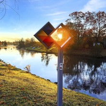 Sunrise over the Lippe river with the sign of the discovery route Wasser Wege Winkel, Lippeaue,